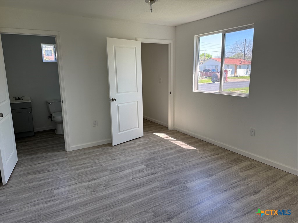 2411 Mumphord Street Victoria, TX 77901 - Photo 8 of 17 an empty room with wooden floor and windows