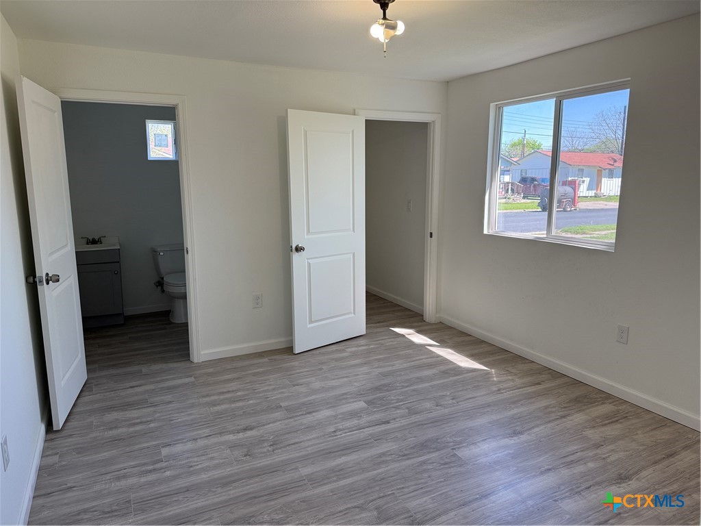 2411 Mumphord Street Victoria, TX 77901 - Photo 9 of 17 wooden floor in an empty room with a window