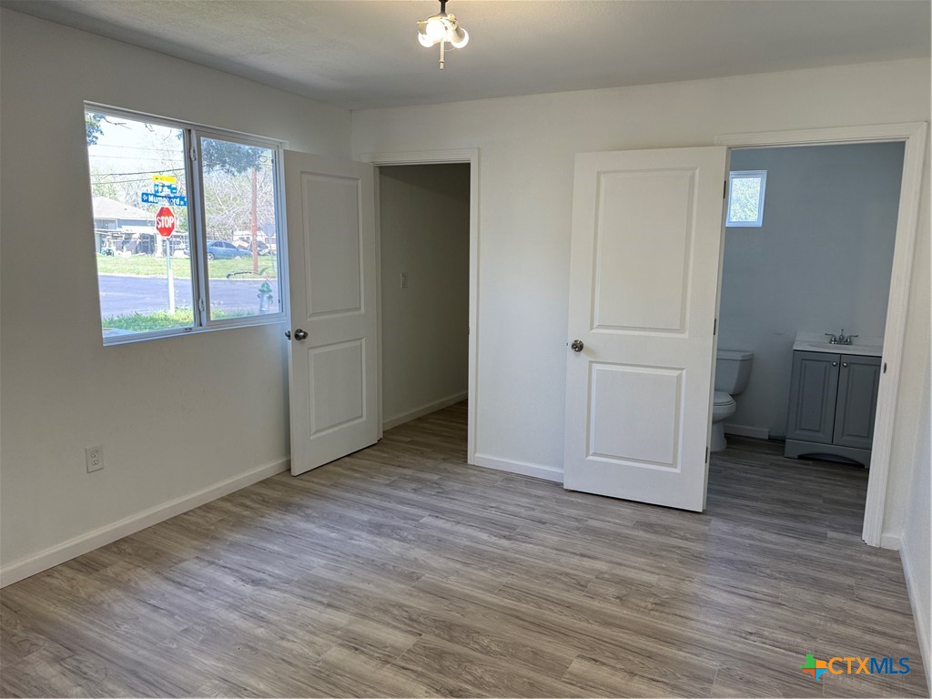2411 Mumphord Street Victoria, TX 77901 - Photo 10 of 17 a view of an empty room with wooden floor and a window