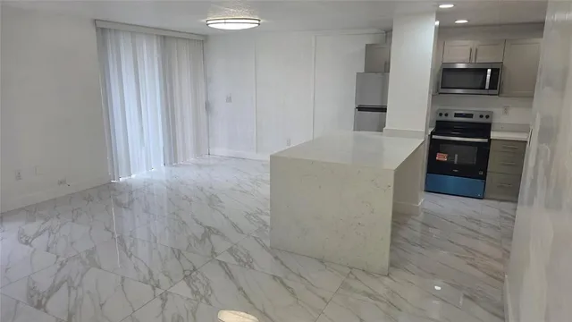 a kitchen with stainless steel appliances a refrigerator and a stove top oven