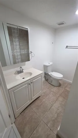 a bathroom with a sink toilet and mirror