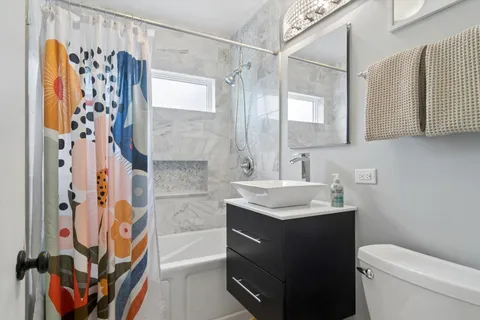 a bathroom with a sink toilet and shower