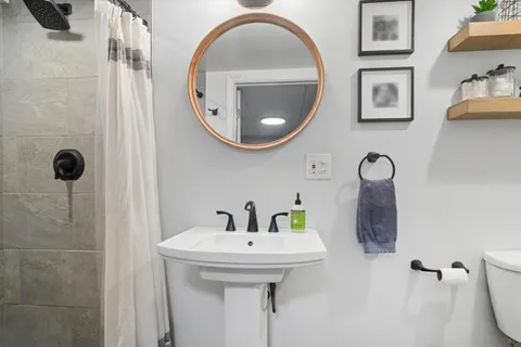 a bathroom with a sink and mirror