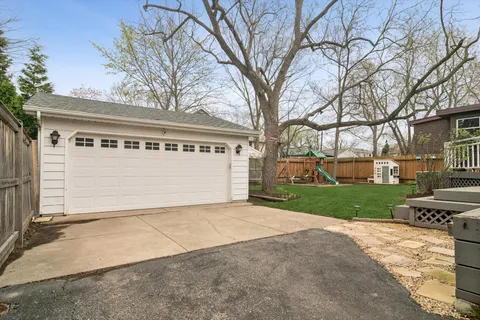 a view of a house with a yard and garage