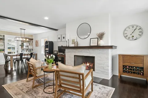 a living room with furniture a clock and a fireplace