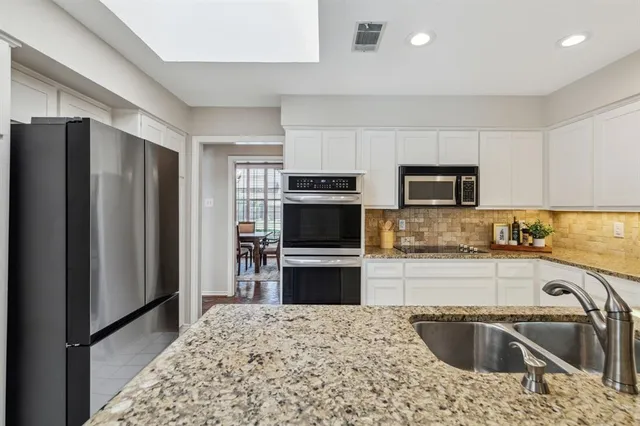 a kitchen with a refrigerator sink and microwave
