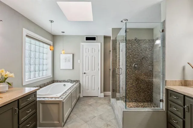 a bathroom with a granite countertop sink a toilet and shower