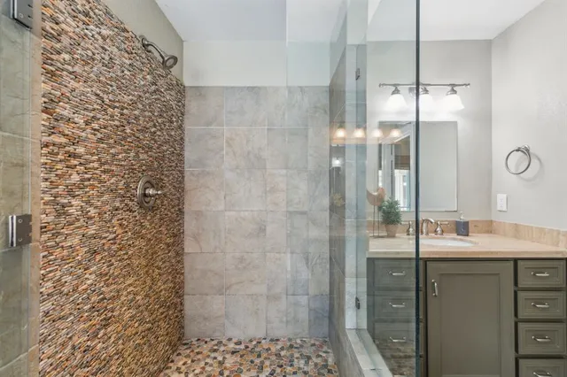 a bathroom with a shower and a sink