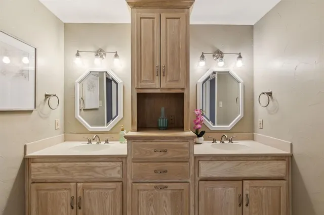 a bathroom with a double vanity sink mirror and