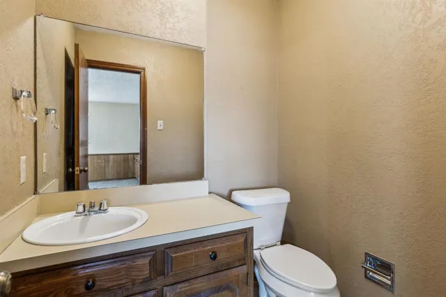 a bathroom with a sink a toilet and mirror