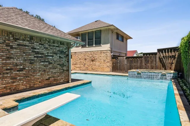 a view of backyard with wooden fence