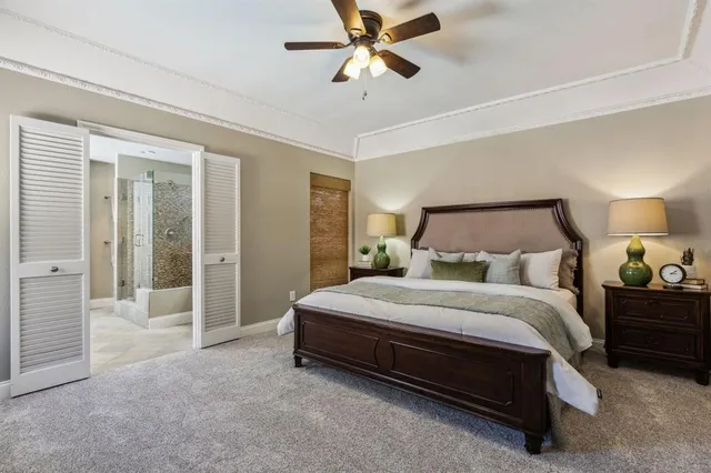 a spacious bedroom with a bed and a chandelier