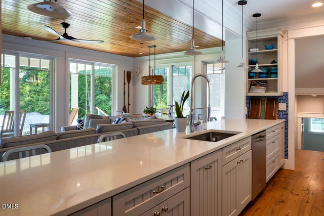 a living room with furniture a flat screen tv and a large window