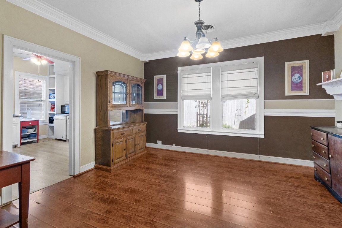 205 Jephson Street Alvin, TX 77511 - Photo 11 of 40 a view of a kitchen with a sink dishwasher and wooden floor