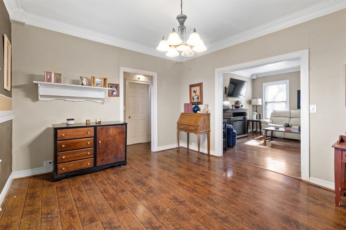 205 Jephson Street Alvin, TX 77511 - Photo 12 of 40 a view of a bedroom with cabinet cabinet cabinet and a chandelier