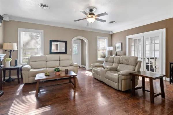 a living room with furniture and wooden floor