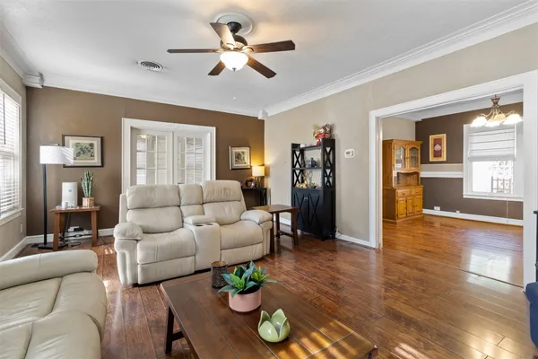 a living room with furniture and wooden floor