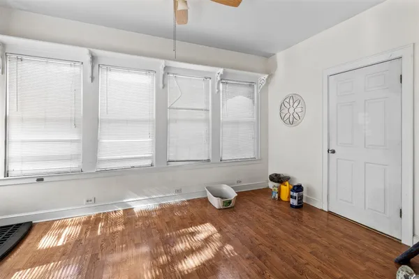 a view of a livingroom with wooden floor and a window