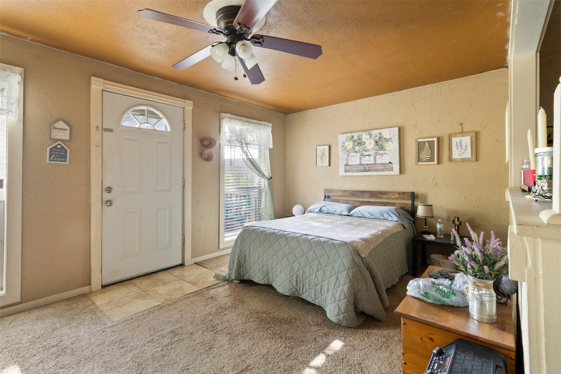 205 Jephson Street Alvin, TX 77511 - Photo 29 of 40 a spacious bedroom with a bed and a chandelier