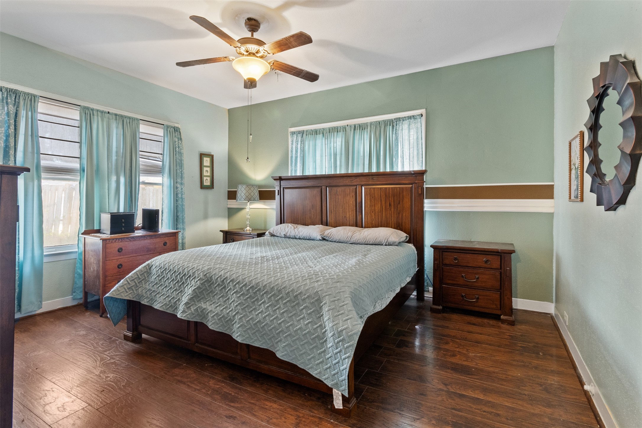 205 Jephson Street Alvin, TX 77511 - Photo 3 of 40 a bedroom with a bed and wooden floor