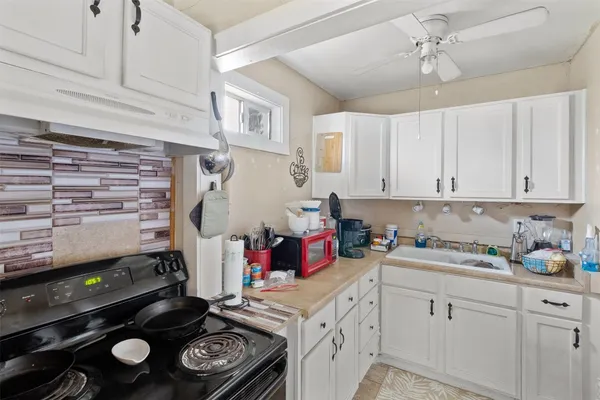 a kitchen with a stove and cabinets