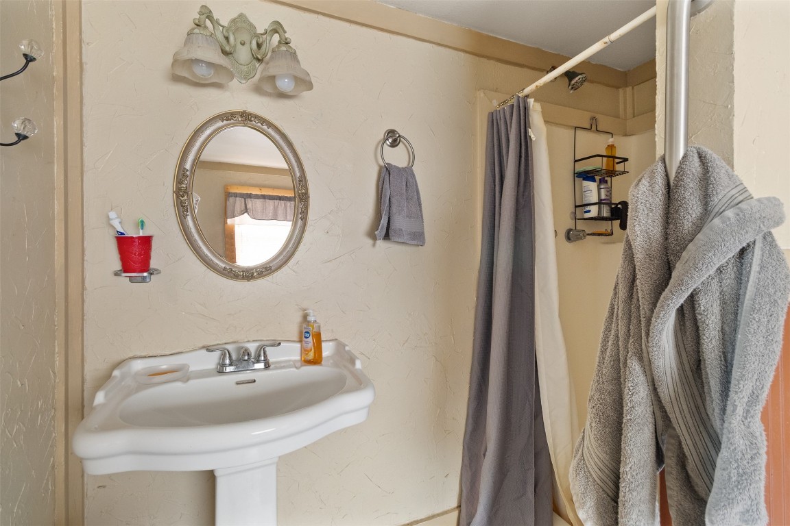 205 Jephson Street Alvin, TX 77511 - Photo 33 of 40 a bathroom with a sink a mirror a vanity and a shower