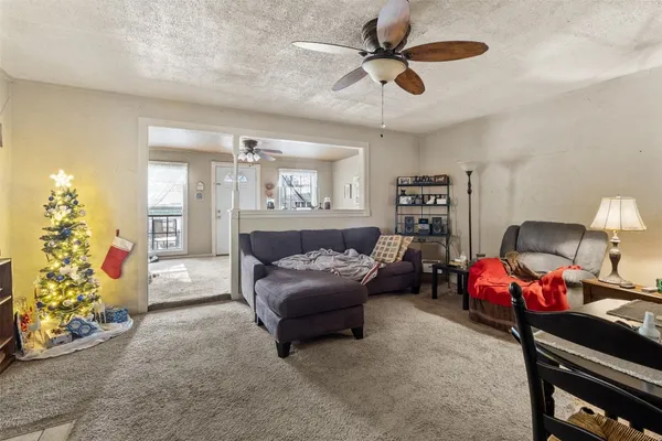 a living room with furniture and a chandelier