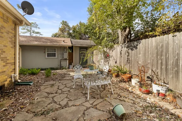 a backyard of a house with table and chairs