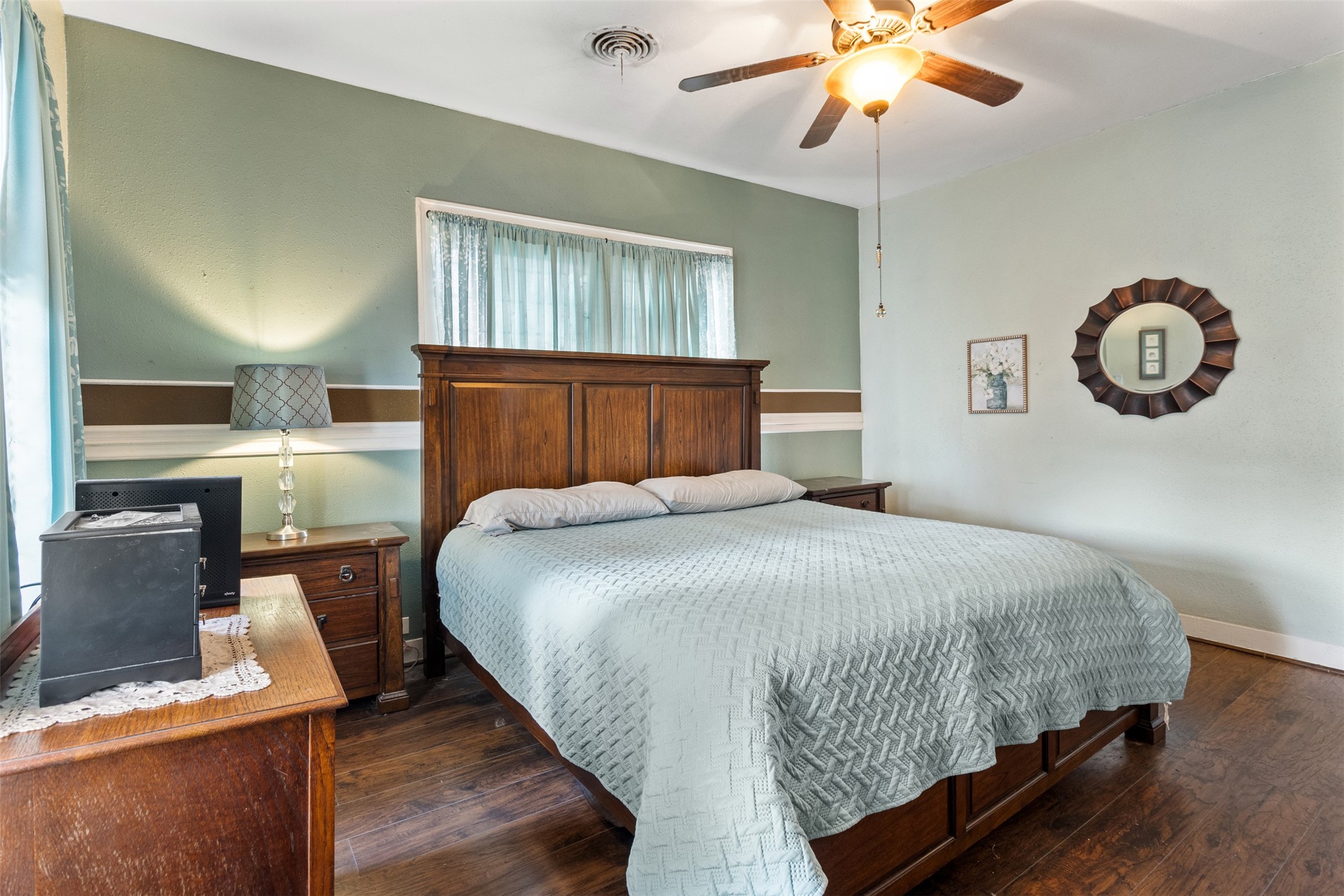 205 Jephson Street Alvin, TX 77511 - Photo 4 of 40 a bedroom with a bed and a chandelier