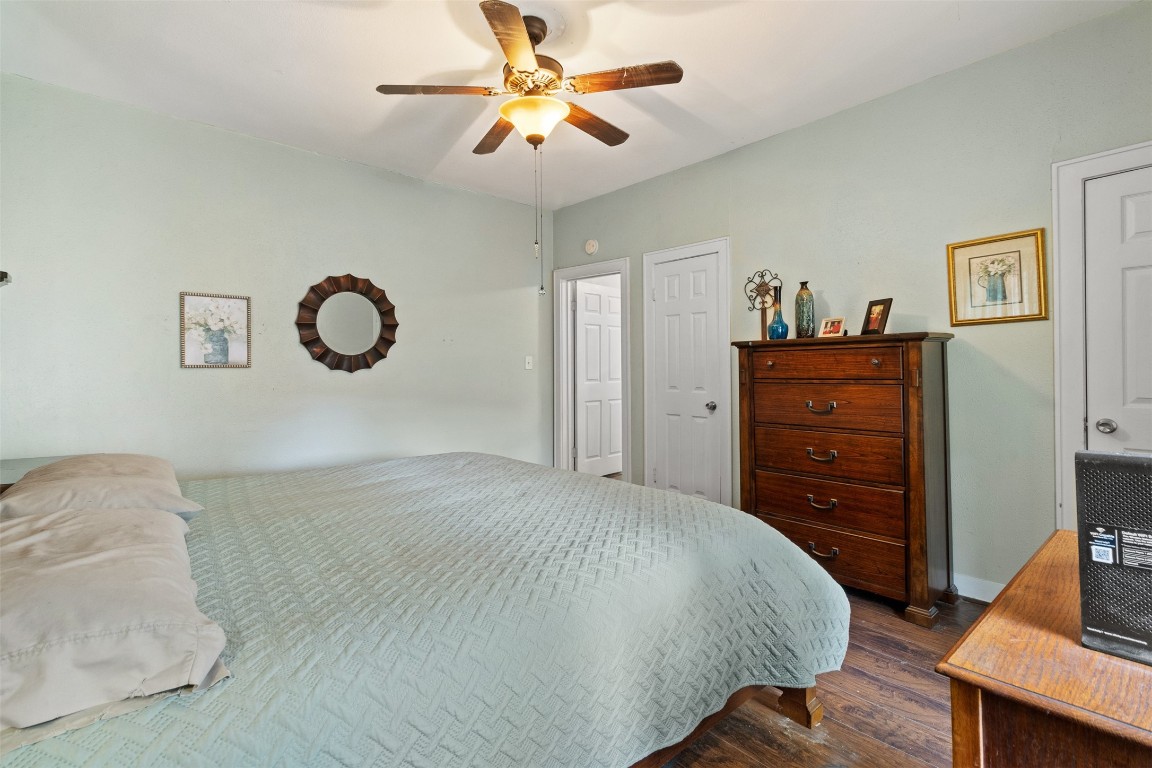 205 Jephson Street Alvin, TX 77511 - Photo 5 of 40 a bedroom with a bed and a chandelier
