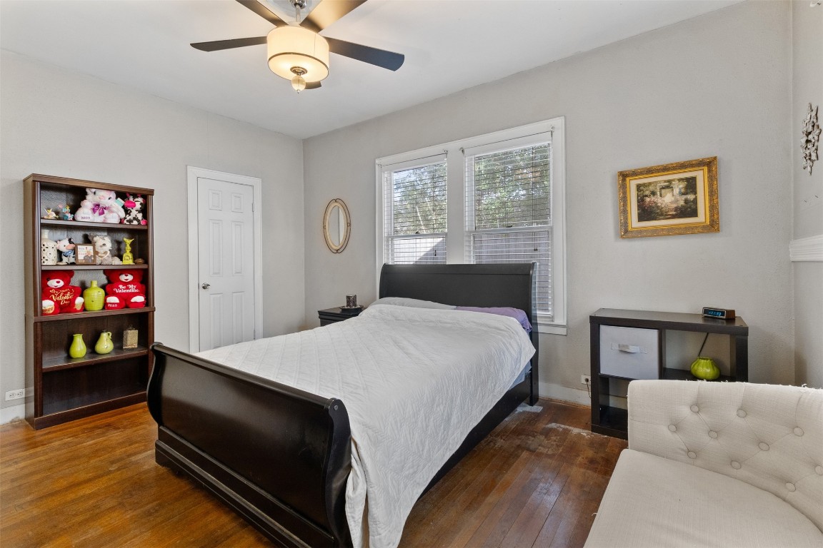 205 Jephson Street Alvin, TX 77511 - Photo 9 of 40 a bedroom with a bed and wooden floor