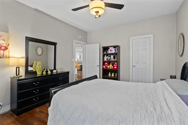 a bedroom with a bed and a dresser in it
