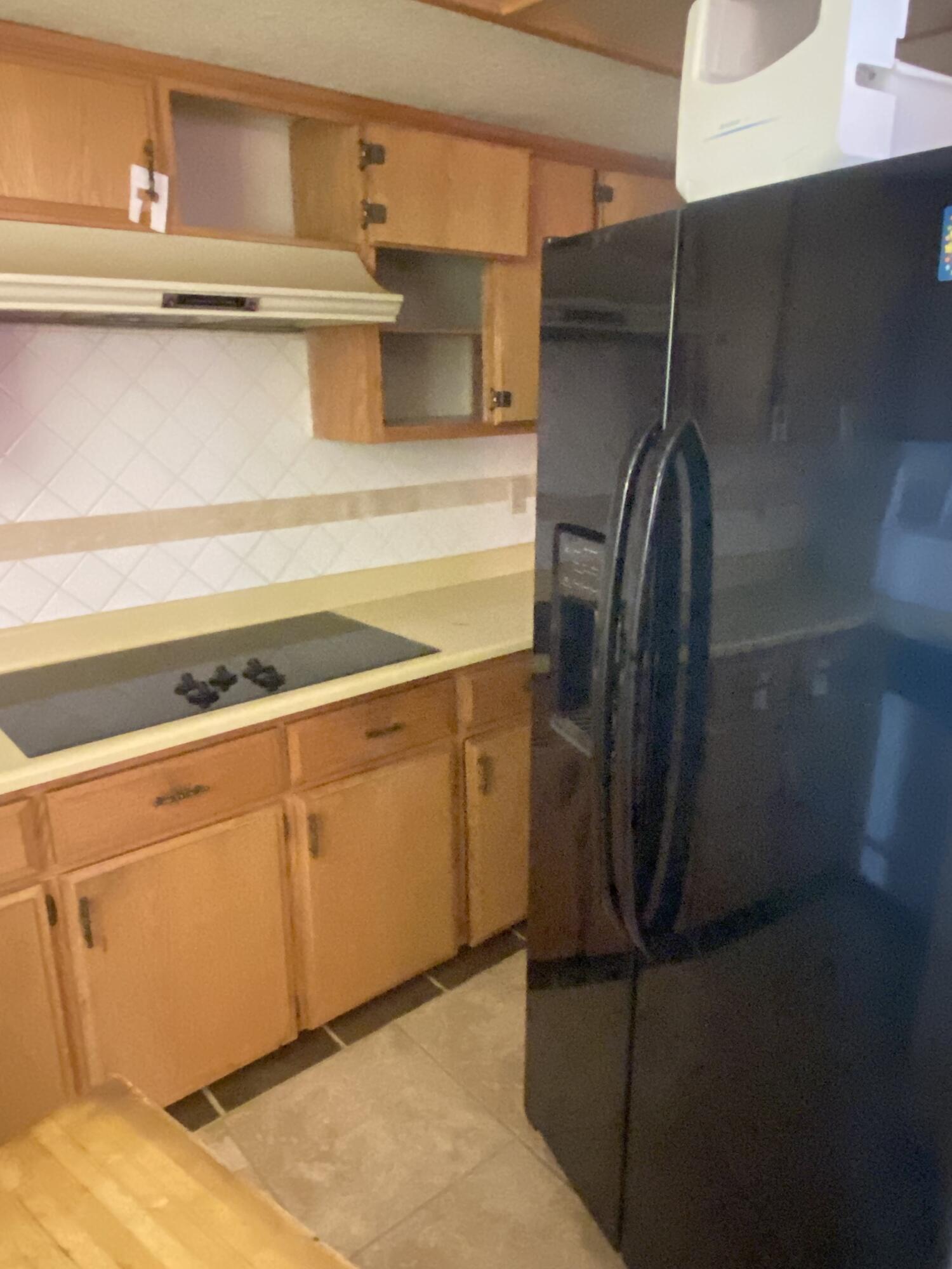 6784 Outpost Road Joshua Tree, CA 92252 - Photo 11 of 22 a kitchen with a refrigerator and cabinets
