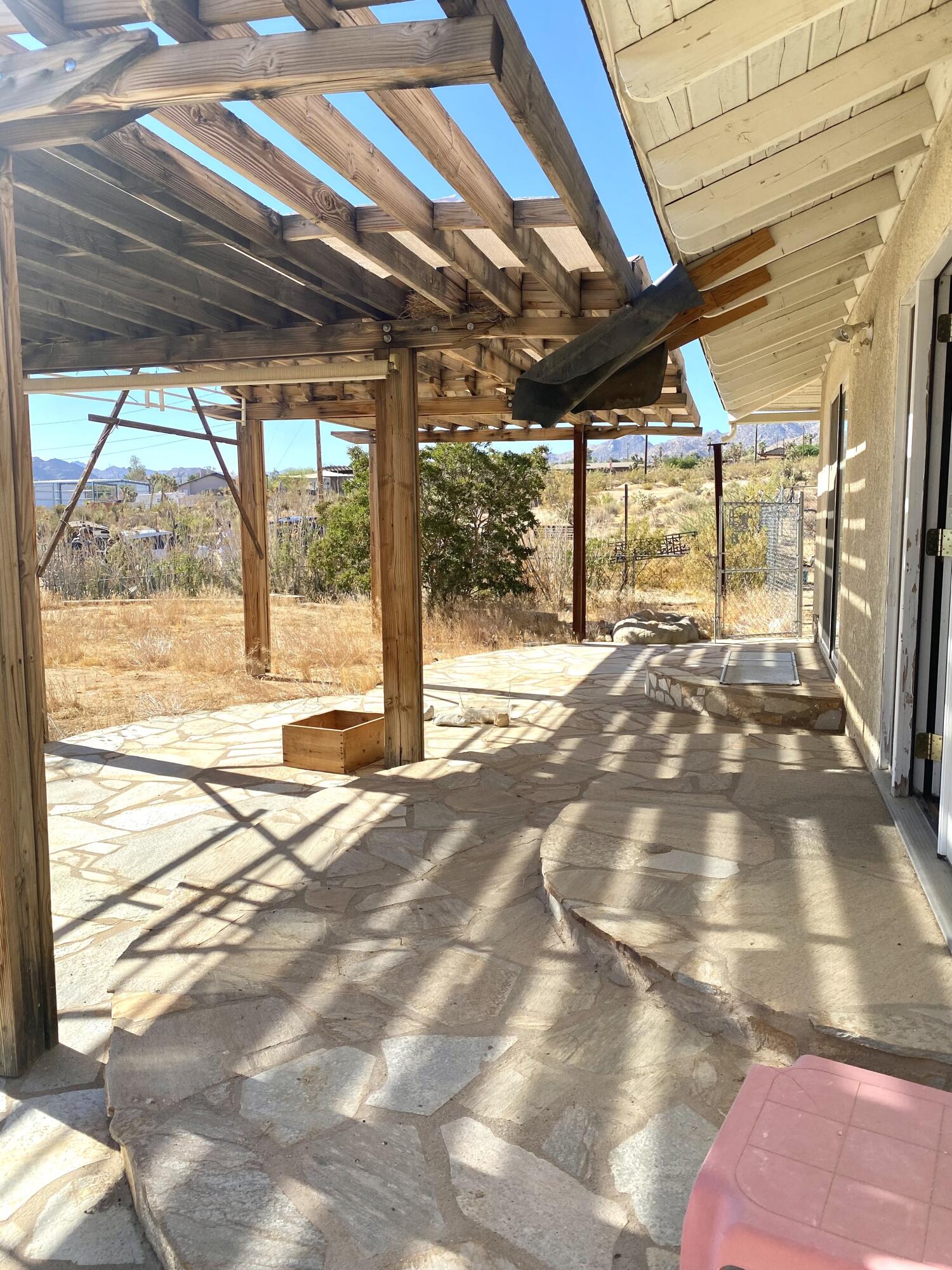6784 Outpost Road Joshua Tree, CA 92252 - Photo 15 of 22 a view of an empty room with a balcony