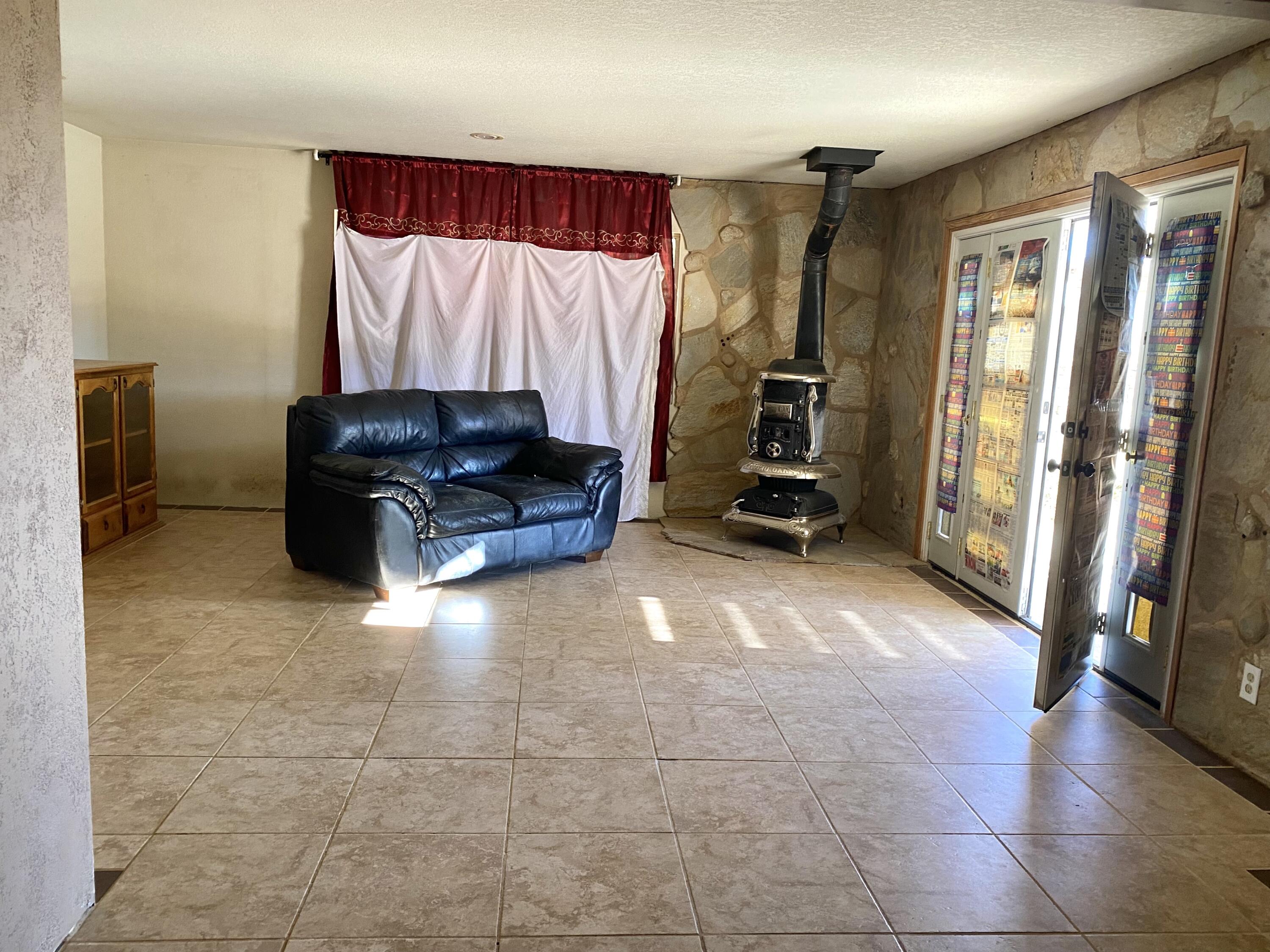 6784 Outpost Road Joshua Tree, CA 92252 - Photo 3 of 22 a view of a livingroom with furniture and a window