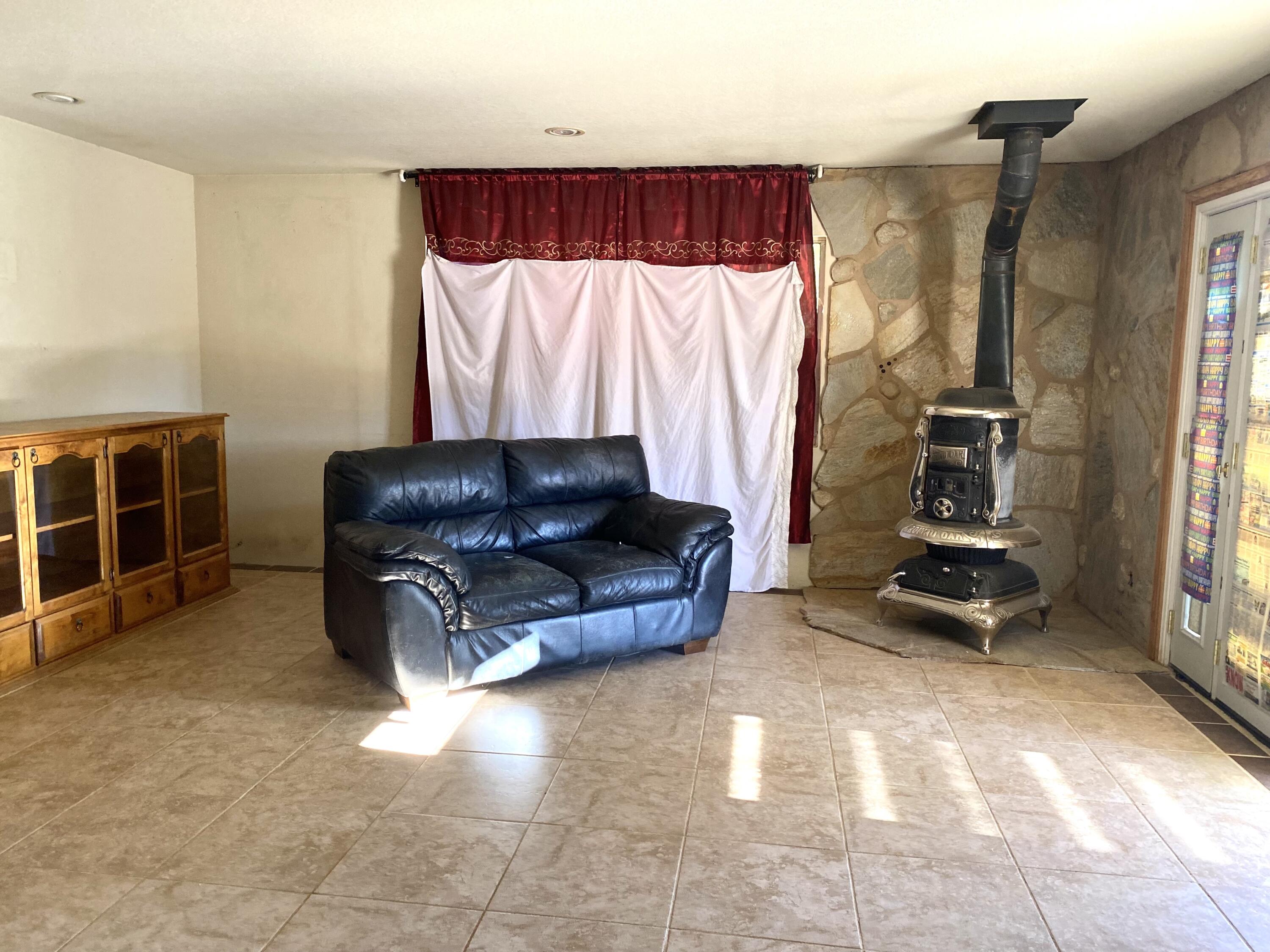 6784 Outpost Road Joshua Tree, CA 92252 - Photo 4 of 22 a living room with furniture and a flat screen tv