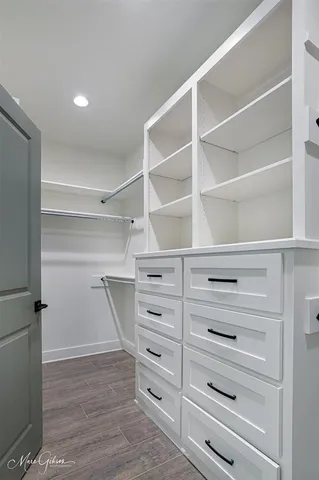 a view of walk in closet with empty racks