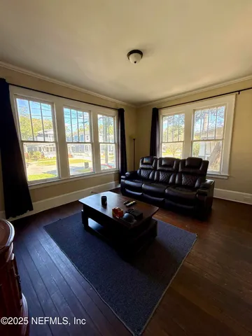 a living room with furniture window and wooden floor
