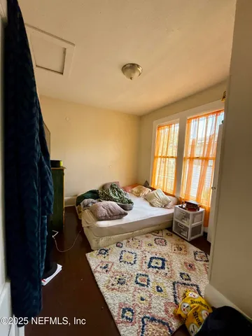 a bedroom with furniture and a window