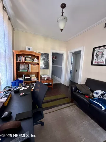 a living room with furniture gym equipment and a window