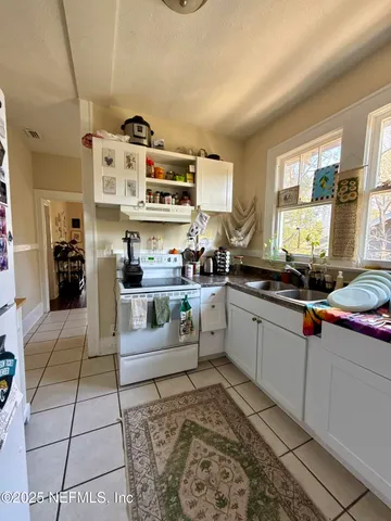 a kitchen with stainless steel appliances kitchen island granite countertop a sink and cabinets