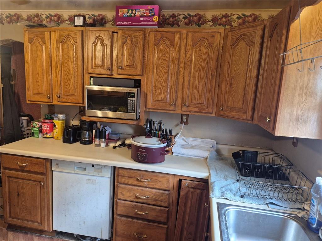 1013 Henry Street Rostraver Township, PA 15012 - Photo 30 of 46 a kitchen with a sink a stove and cabinets