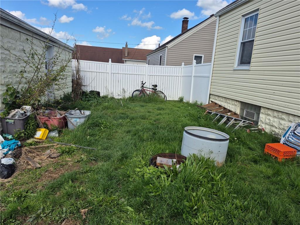 1013 Henry Street Rostraver Township, PA 15012 - Photo 42 of 46 a view of a backyard with plants and a fire pit