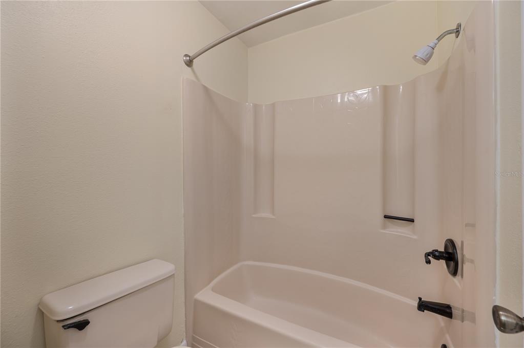 4231 Oak Loop, Unit 51 Mulberry, FL 33860 - Photo 20 of 29 a bathroom with a shower and toilet