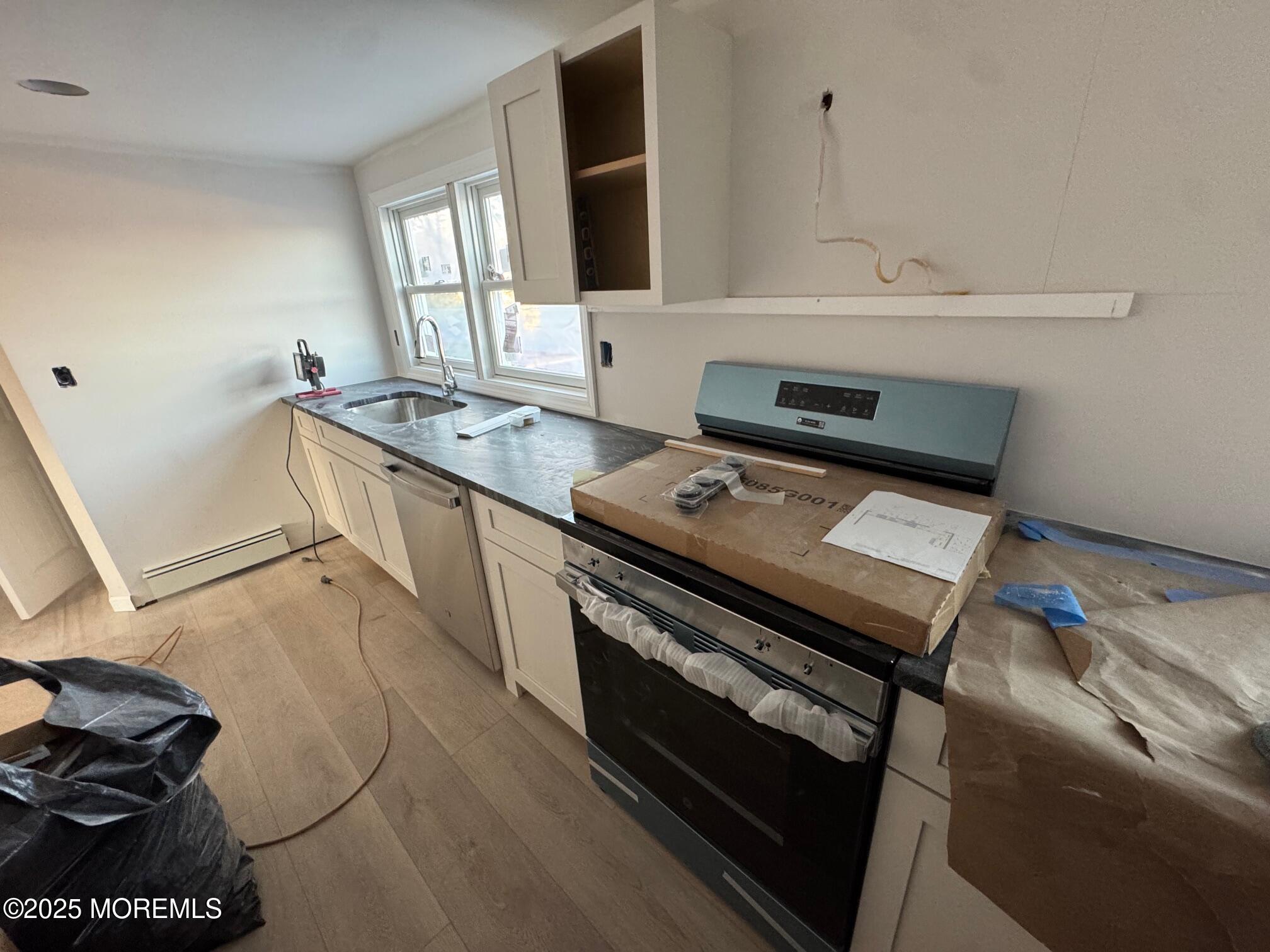 259 Matawan Avenue, Unit 2 Matawan, NJ 07747 - Photo 4 of 10 a kitchen with a stove and a sink