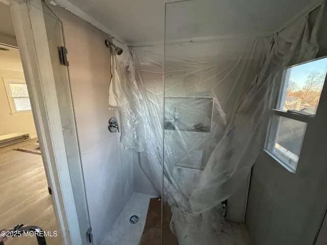 a bathroom with a glass door shower and a sink