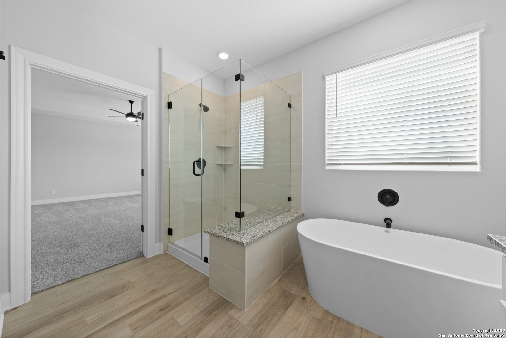 174 Azalea Alley Castroville, TX 78009 - Photo 14 of 22 a bathroom with a tub shower and sink