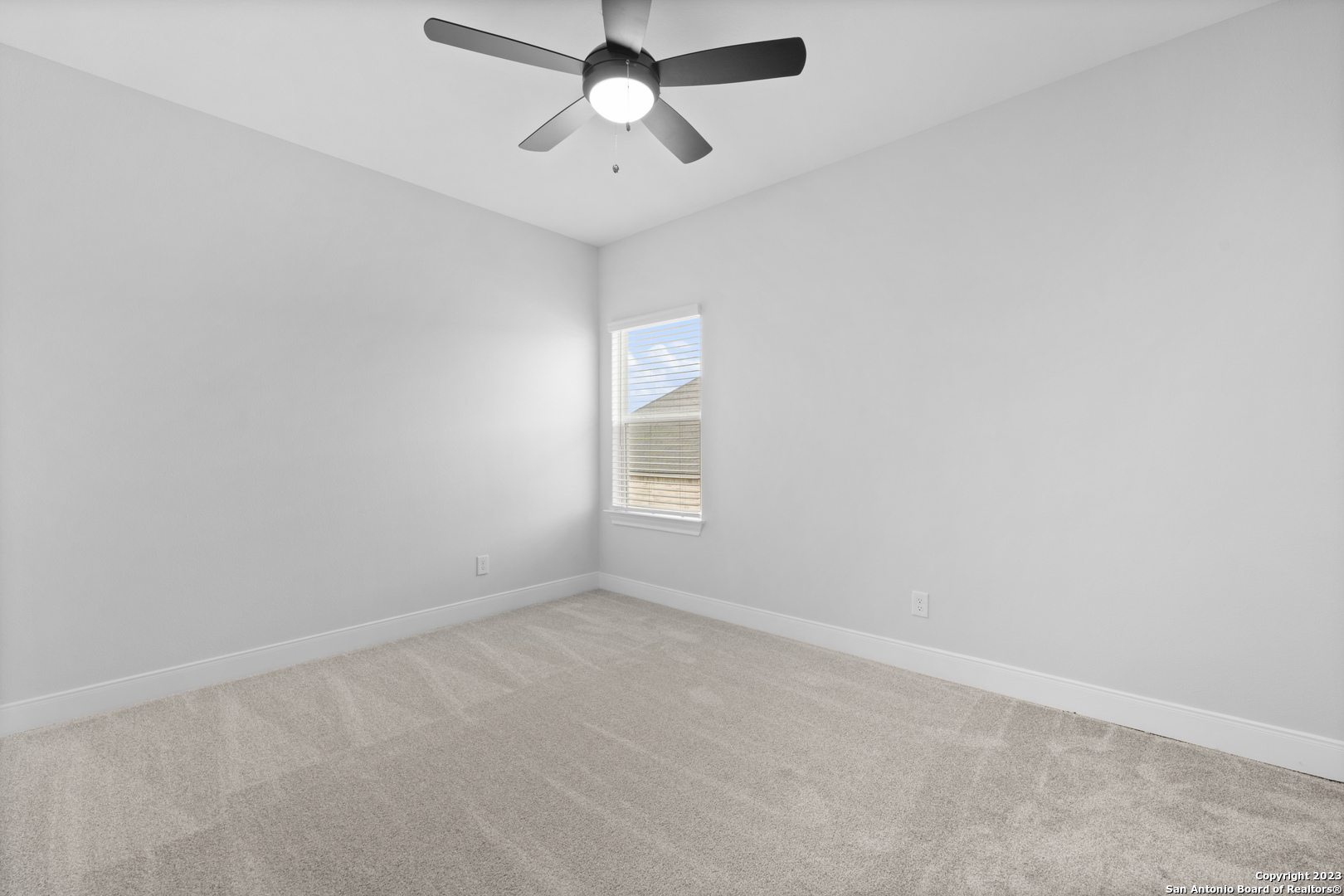 174 Azalea Alley Castroville, TX 78009 - Photo 19 of 22 an empty room with a window and a fan