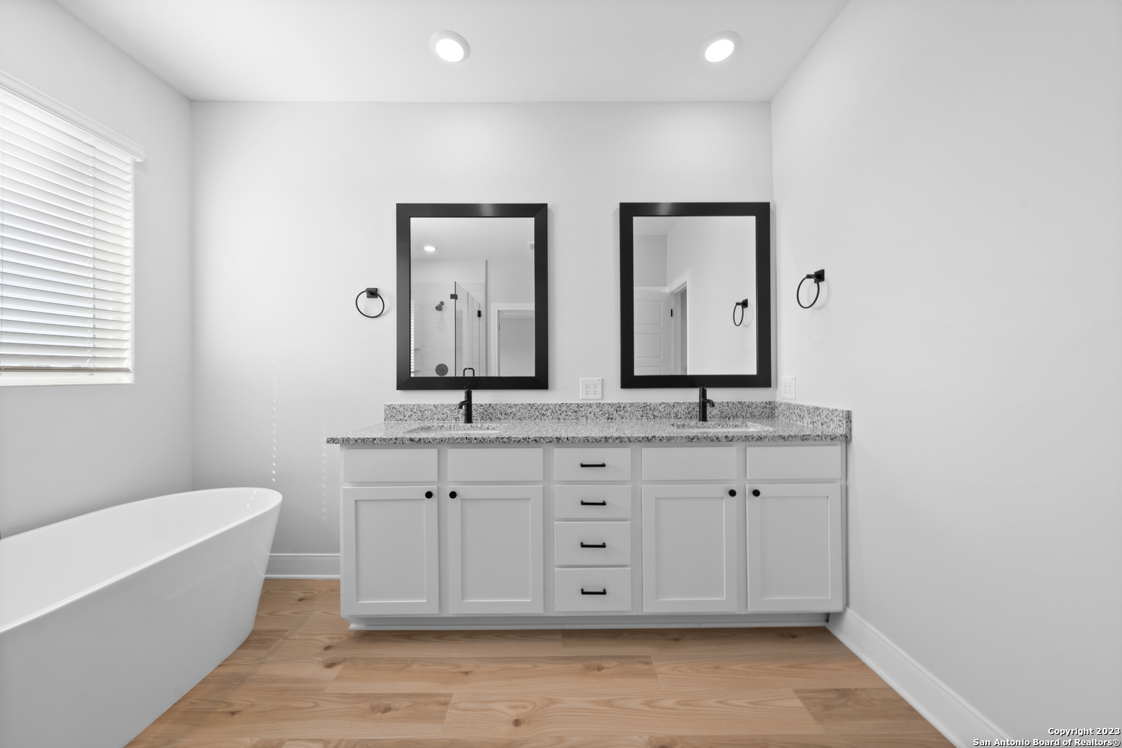 174 Azalea Alley Castroville, TX 78009 - Photo 21 of 22 a bathroom with a granite countertop double vanity sink a mirror and a