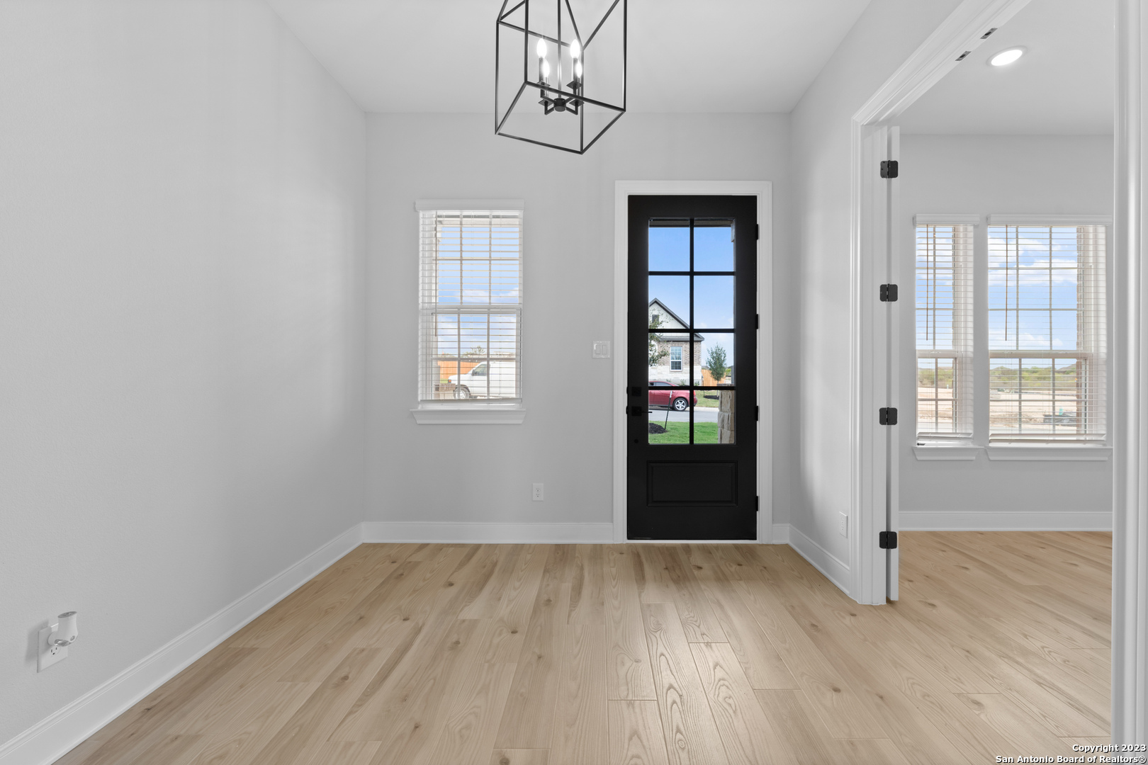 174 Azalea Alley Castroville, TX 78009 - Photo 6 of 22 an empty room with wooden floor and windows